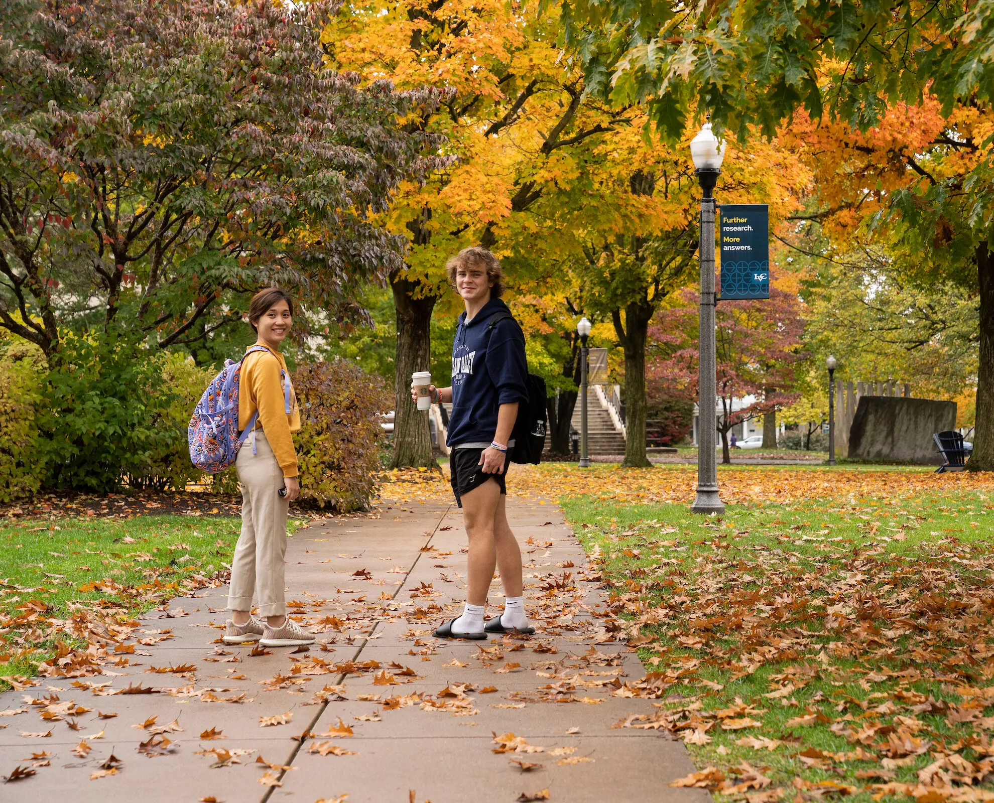 Students walk on campus in fall