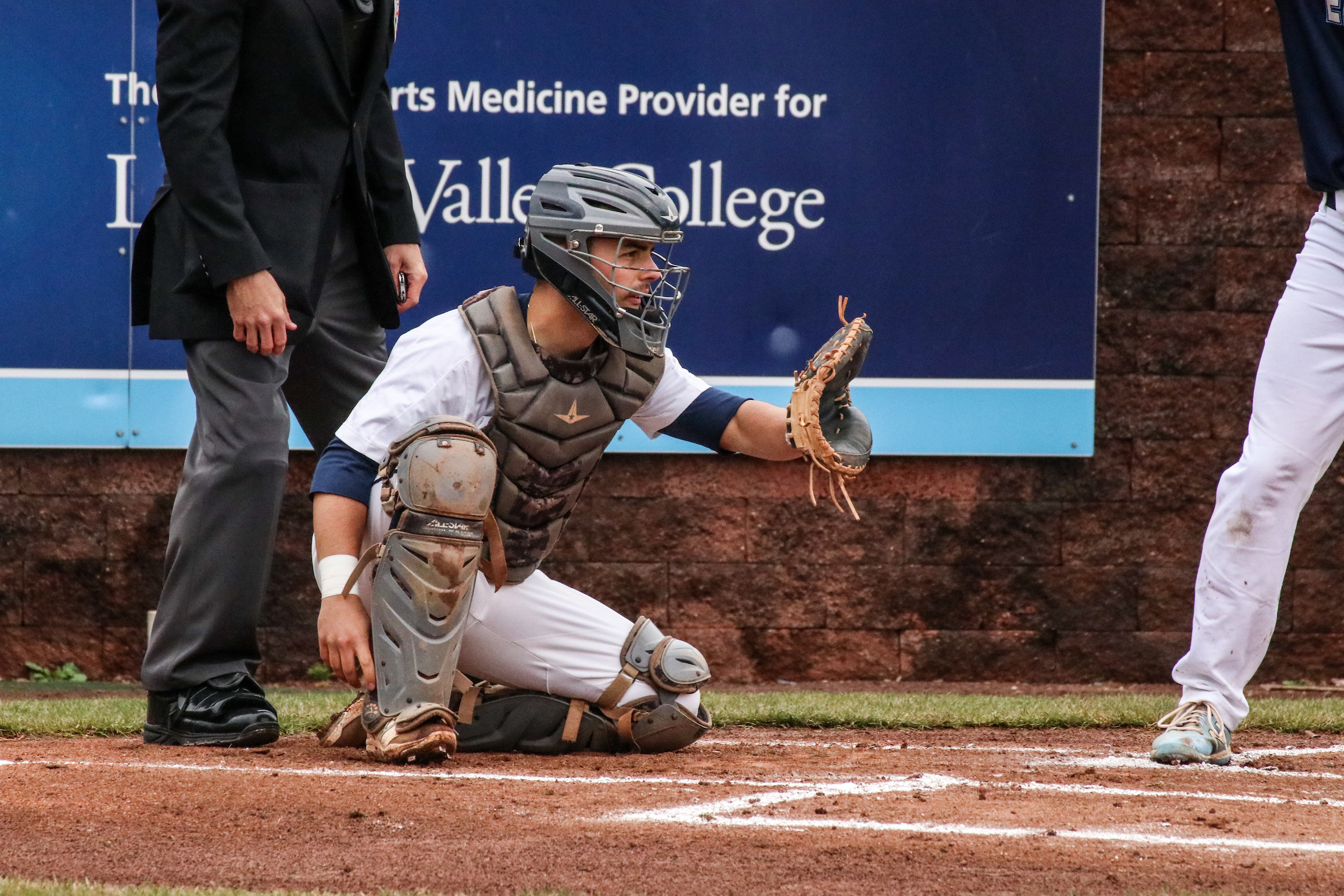 LVC baseball catcher squats behind the plate