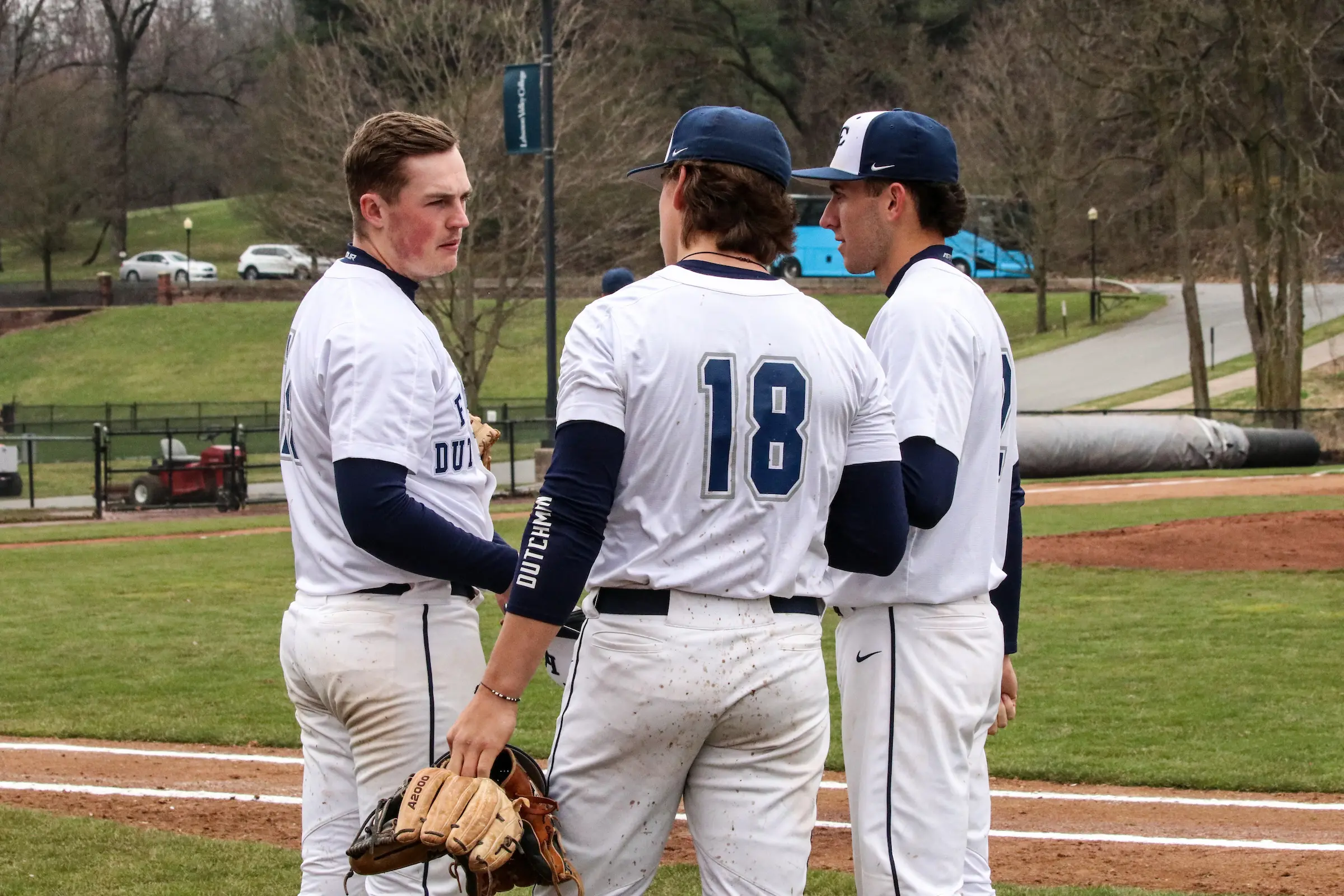 LVC baseball team members in a huddle on field