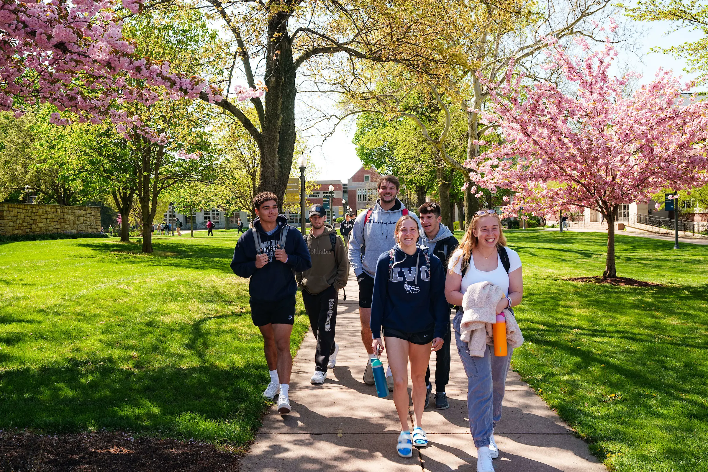 Students walk on campus in spring