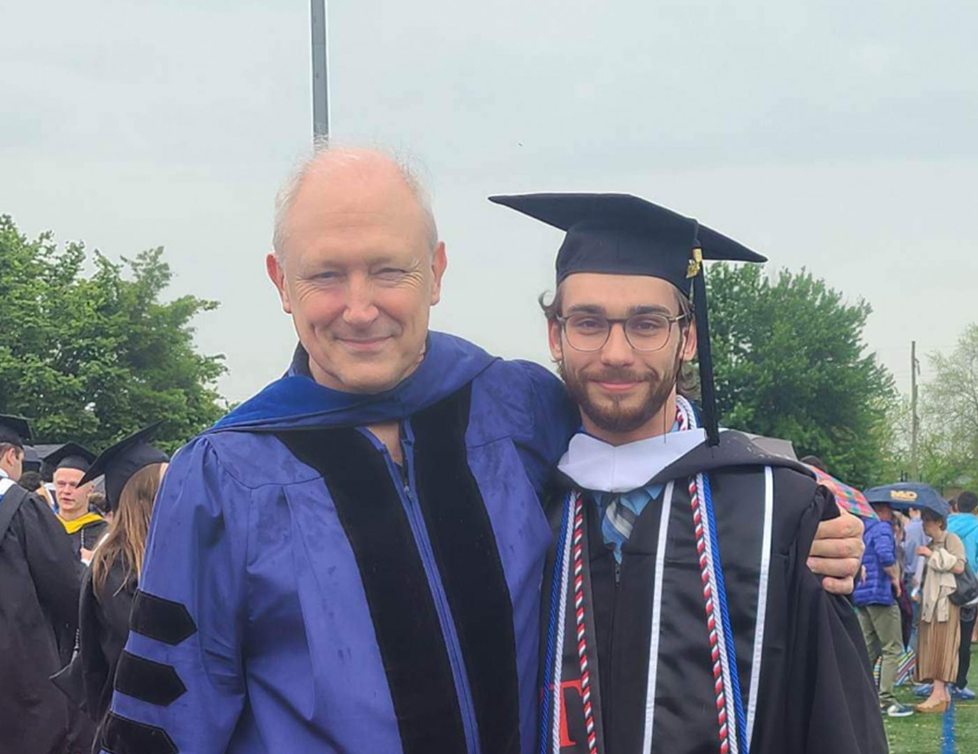 Political science graduate Matthew Davis poses with Dr. Philip Benesch