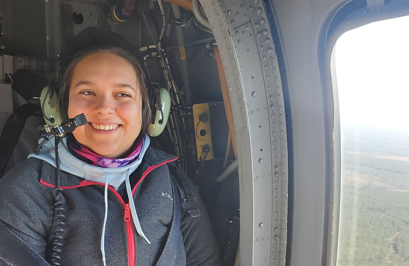 Abigail Corbin rides in a helicopter as part of her environmental science career.