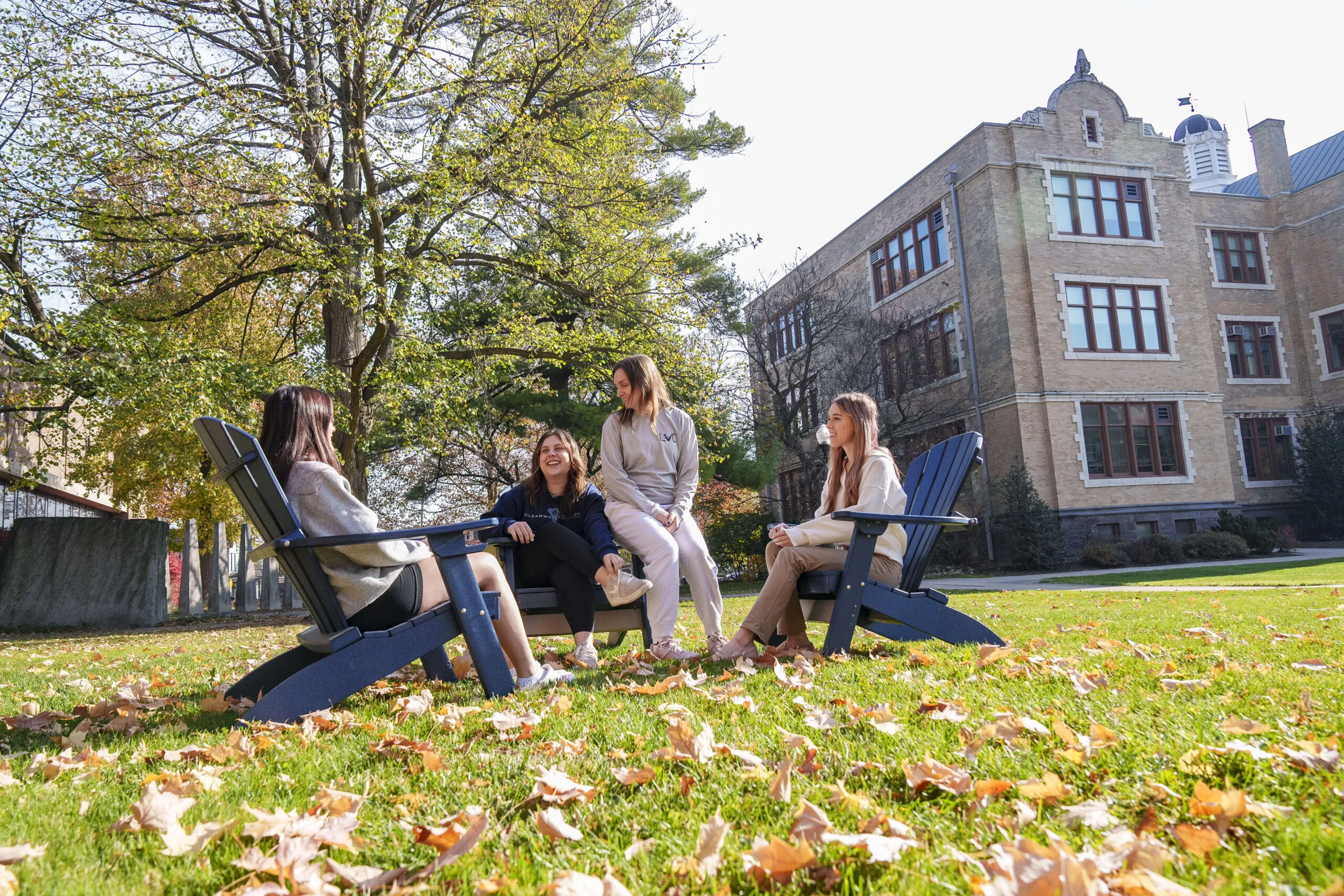 LVC students sit in chairs on academic quad in the fall