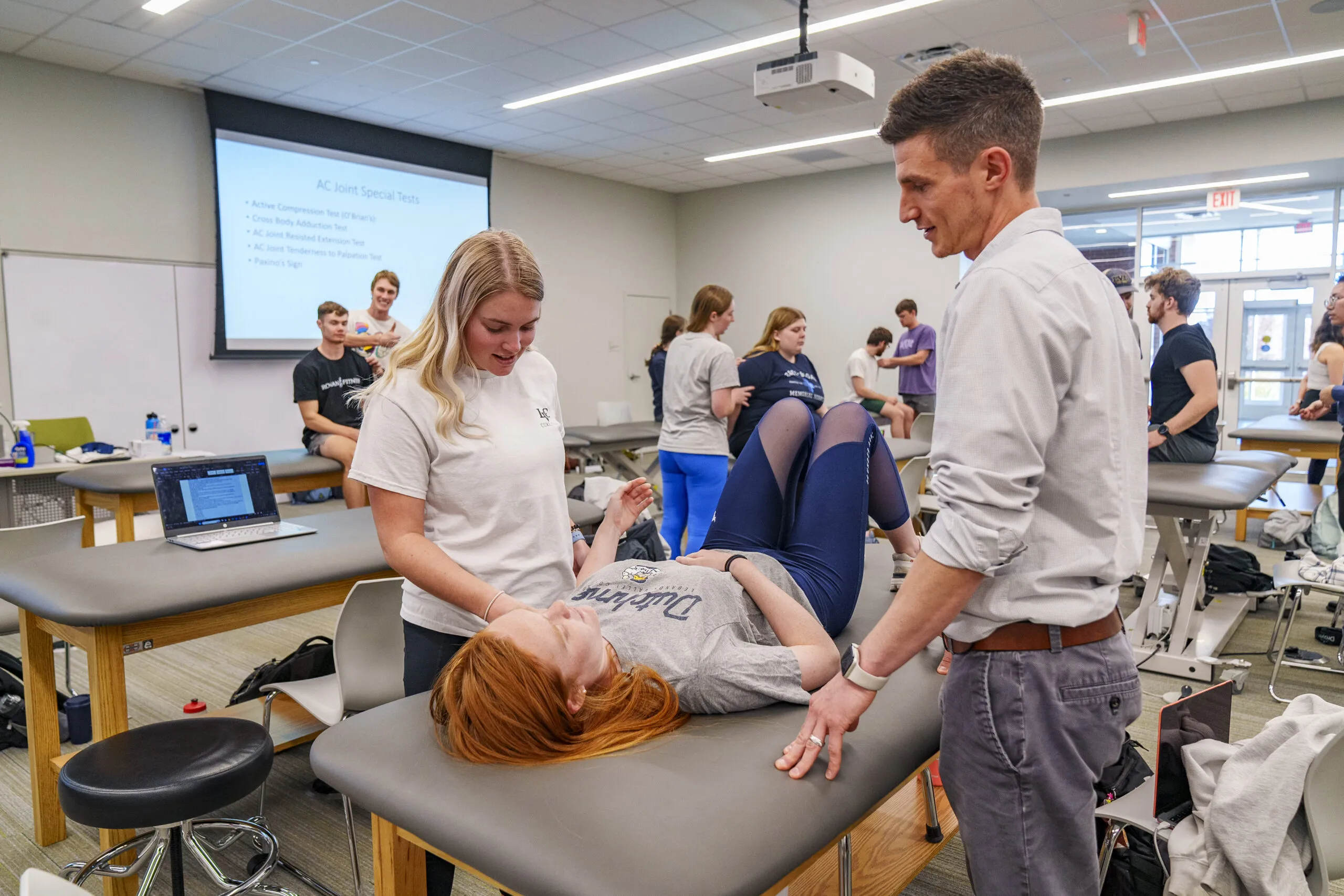 Students practice techniques during physical therapy class.