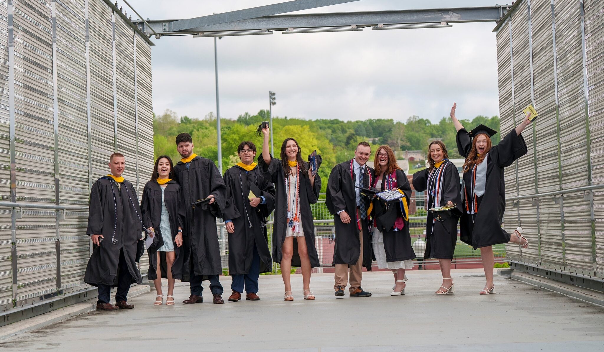 LVC Class of 2024 graduates pose on bridge