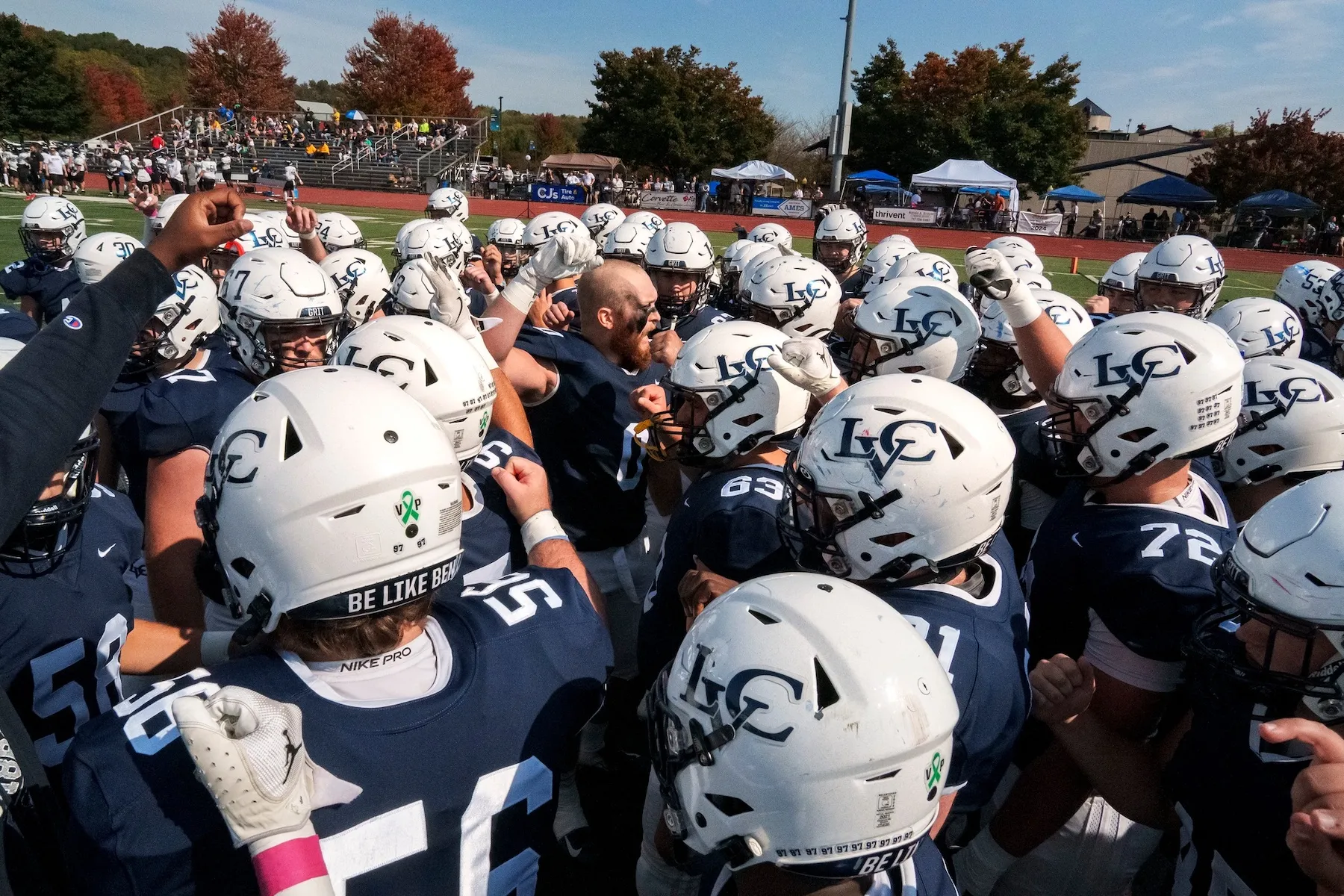 LVC football team in huddle on field