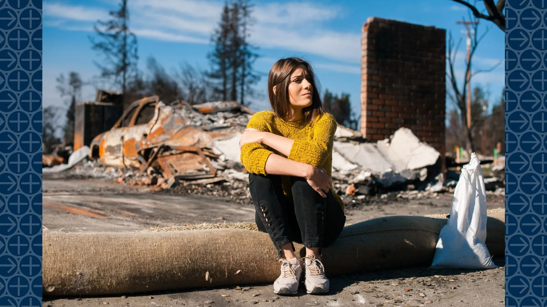Woman sits in aftermath of natural disaster