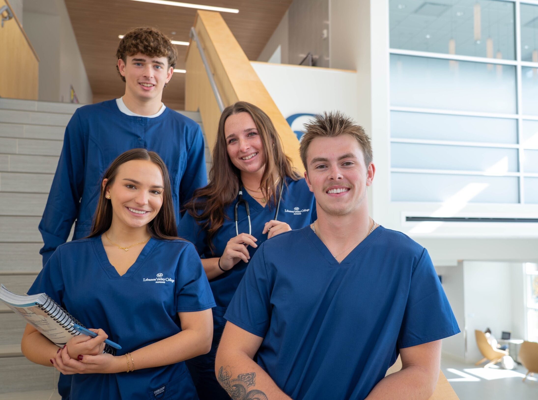 LVC nursing students pose on staircase in nursing building