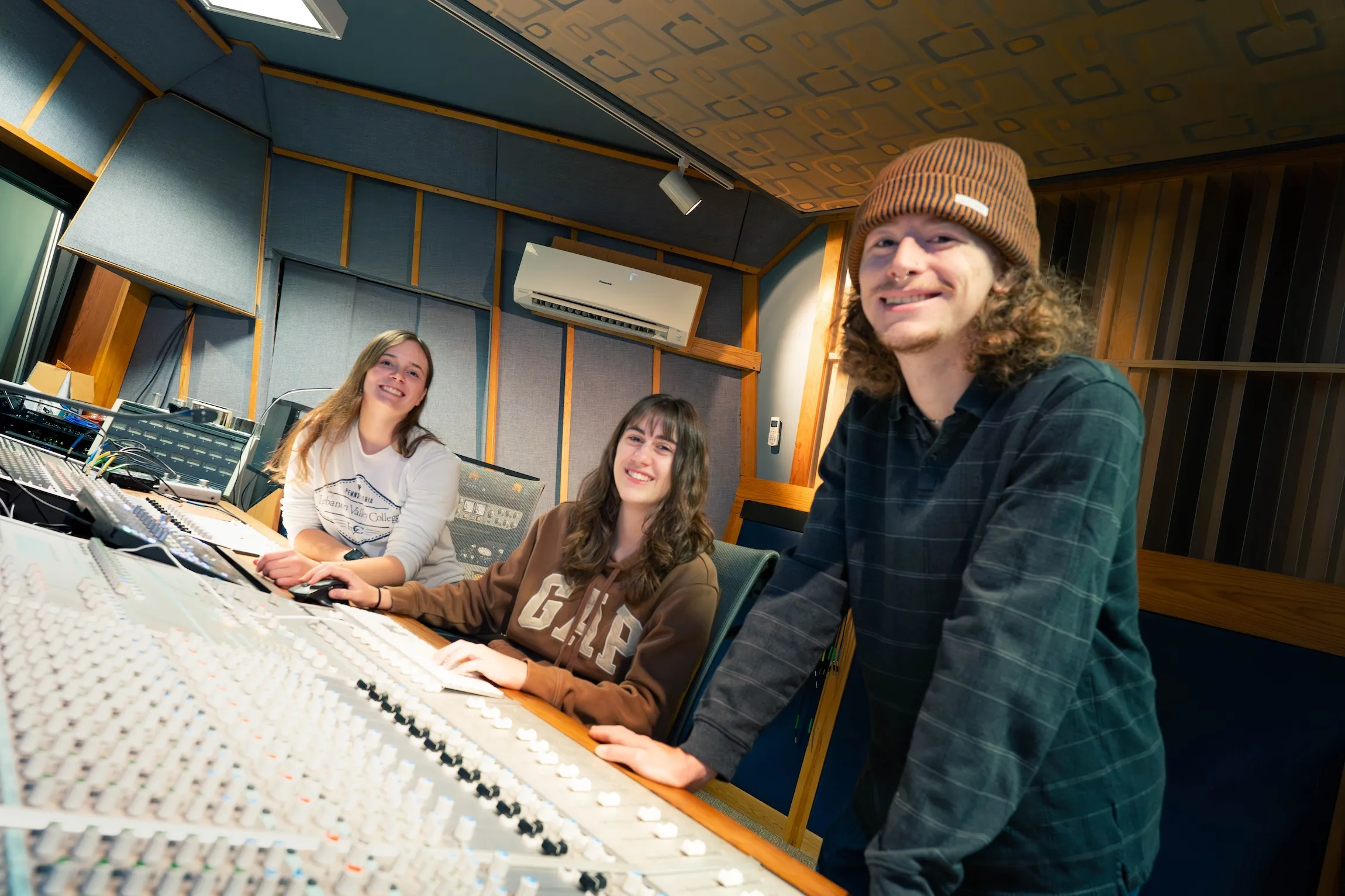Students work in music production studio