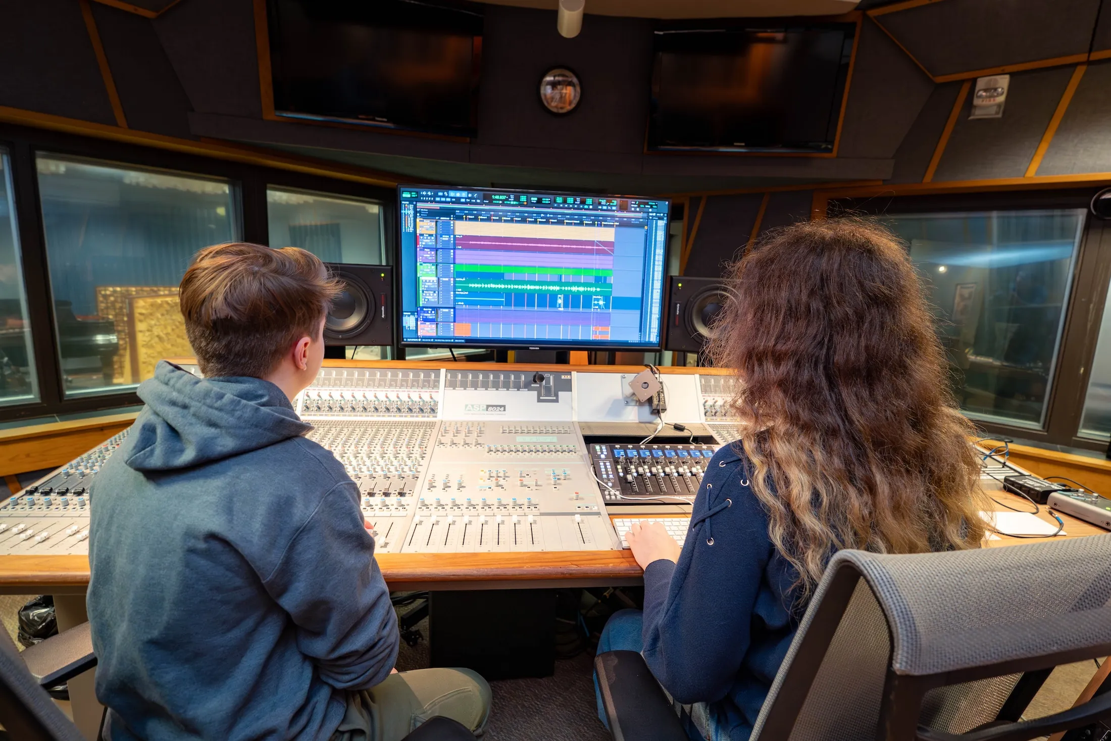 Students work in music production studio