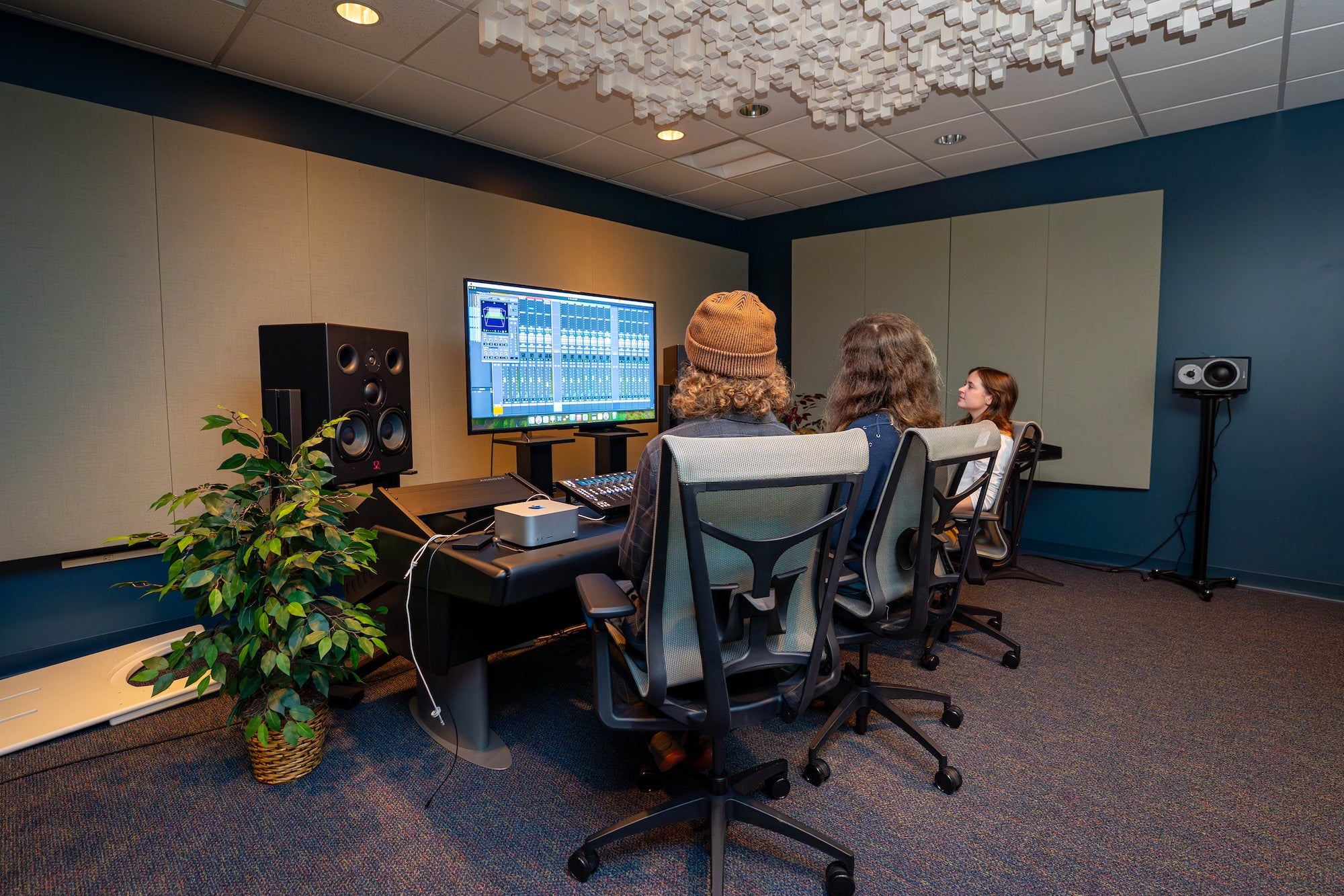 Students work in music production studio