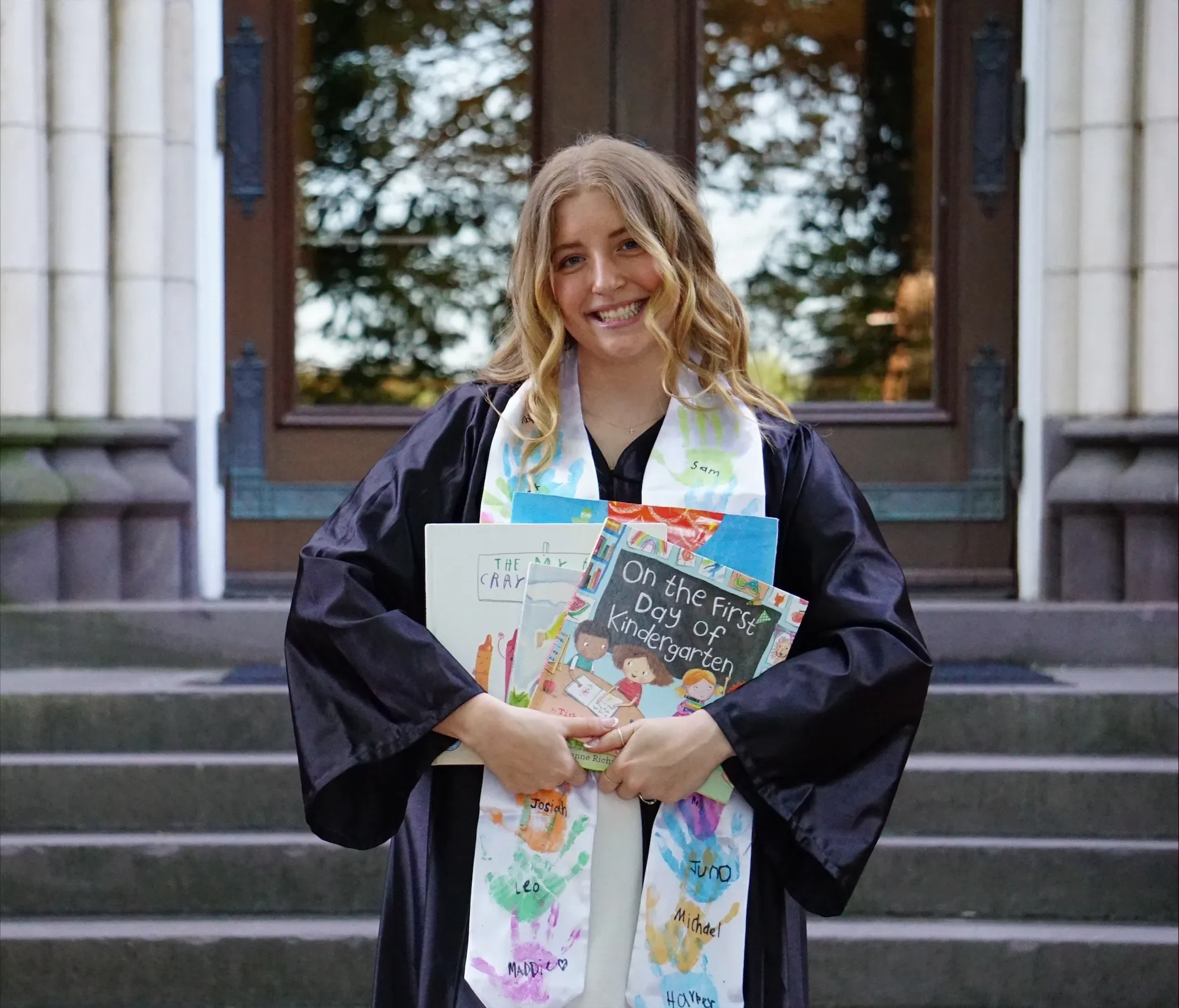 LVC Education graduate holds children's books