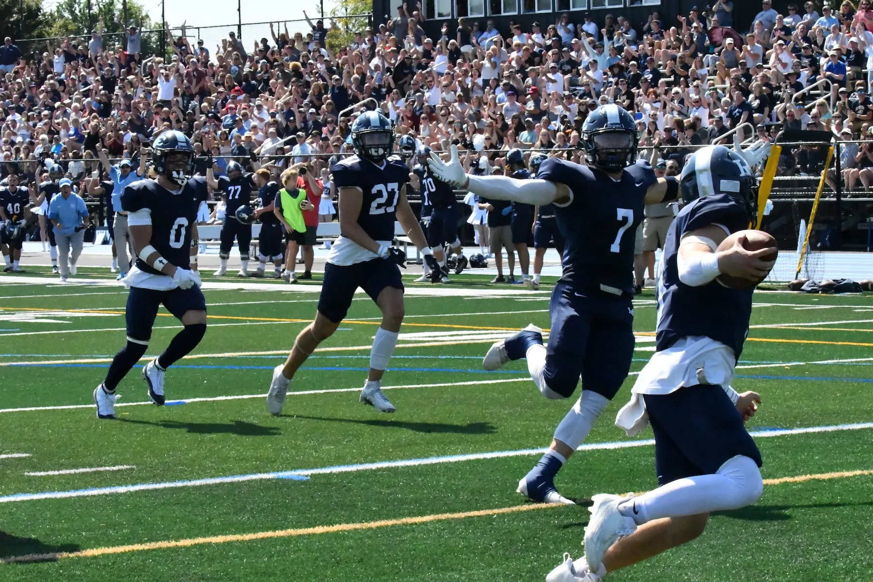 LVC football players run on field