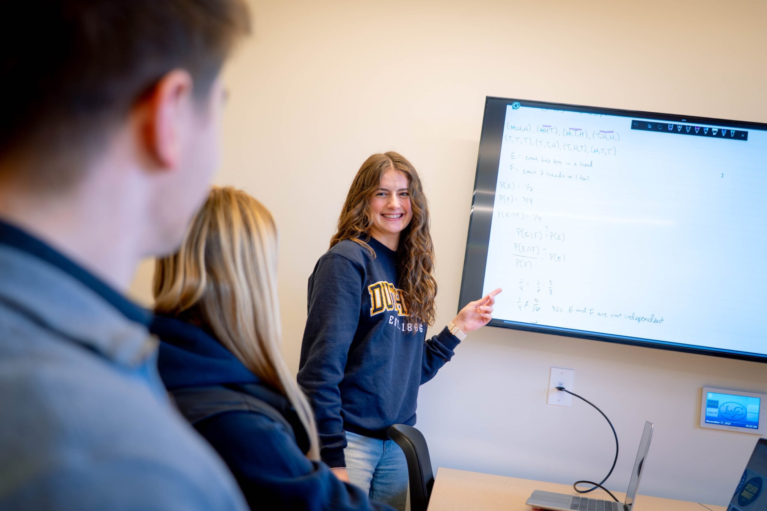 Student points to monitor during study session in Library