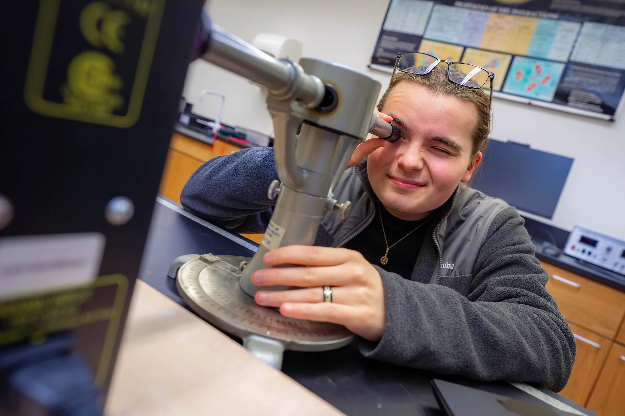 Student uses equipment in physics lab