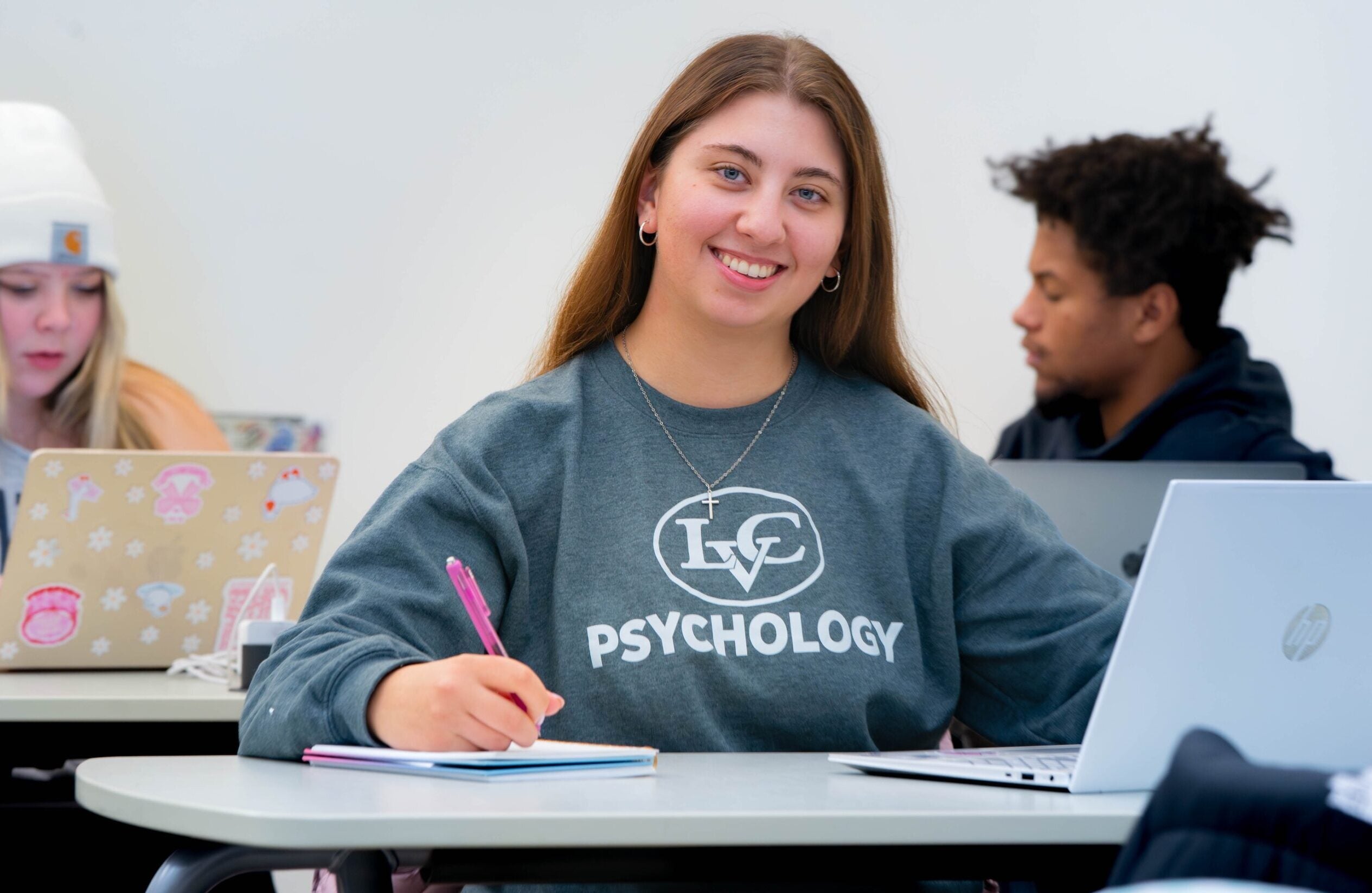 LVC Psychology student smiles at desk