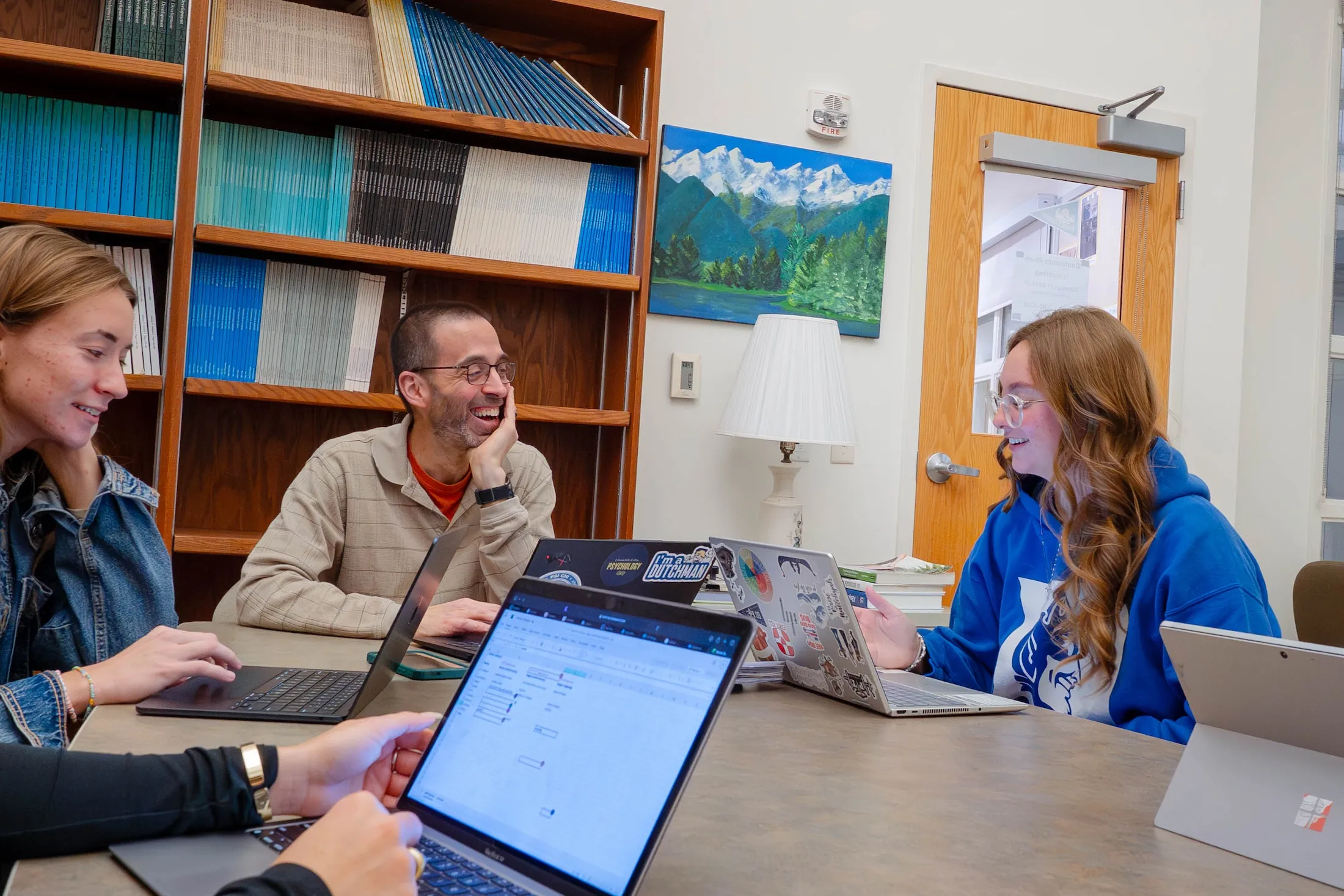 LVC psychology students sit around table with professor