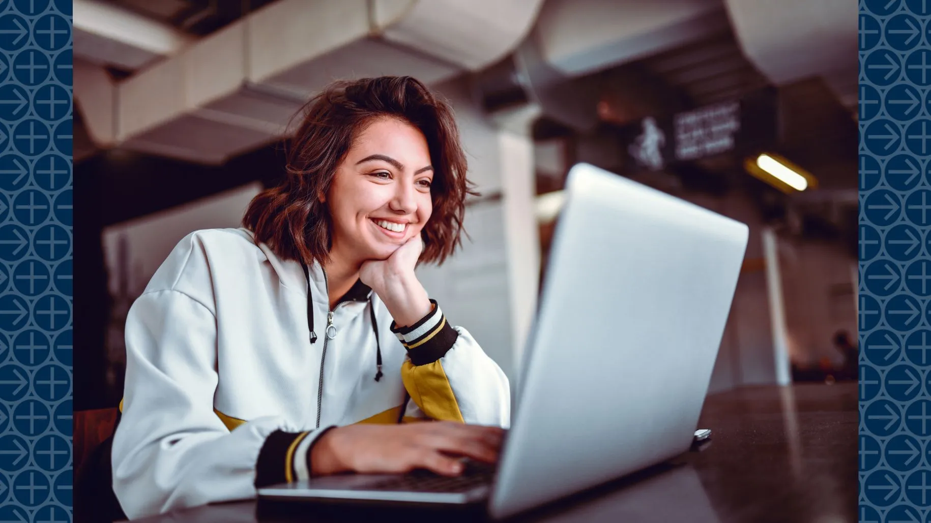 Student smiling looking at laptop