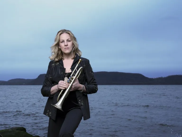 Ingrid Jensen holds trumpet