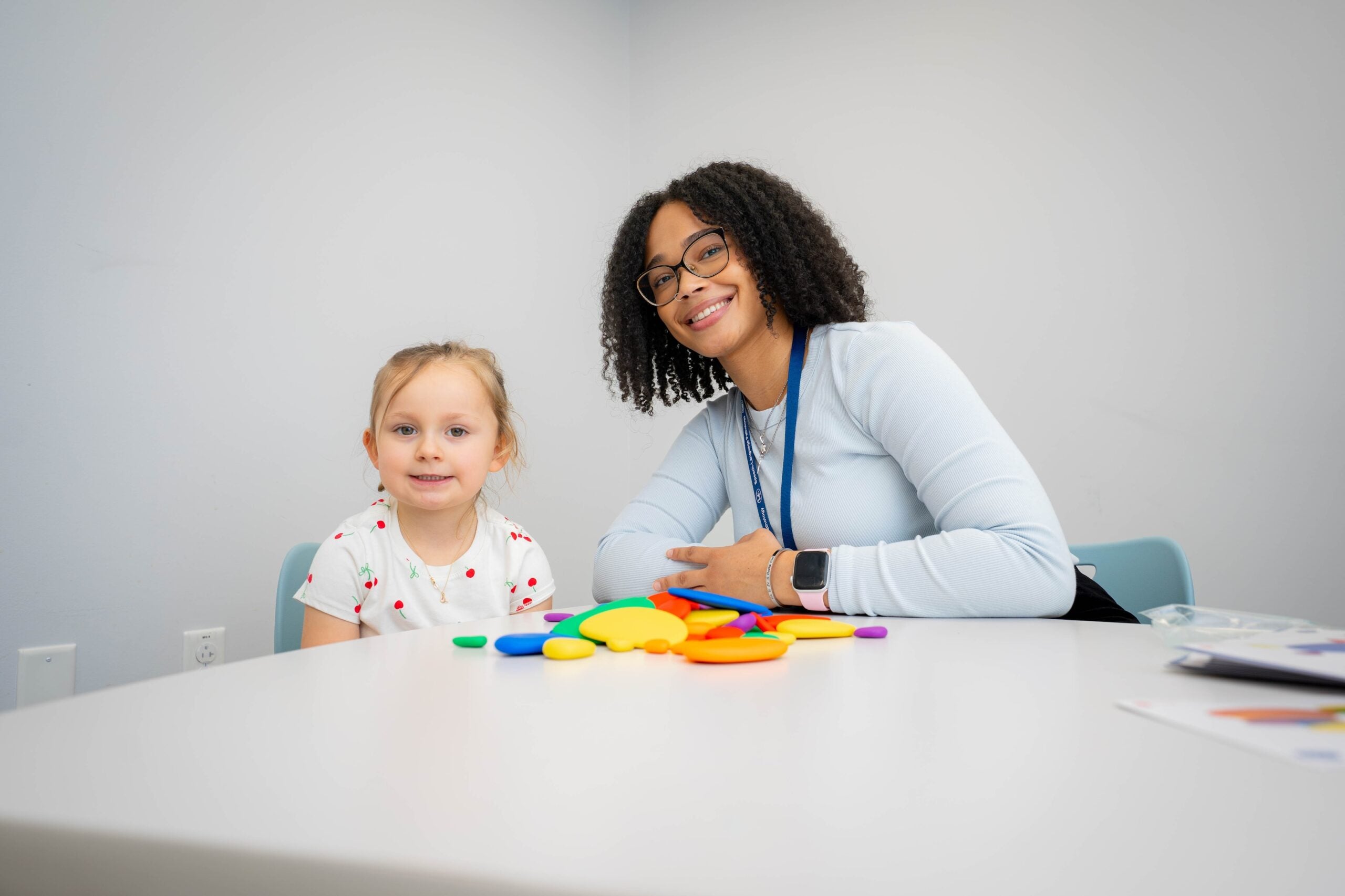 LVC speech-language pathology student smiles with young patient at Center for Speech, Language, & Hearing Disorders