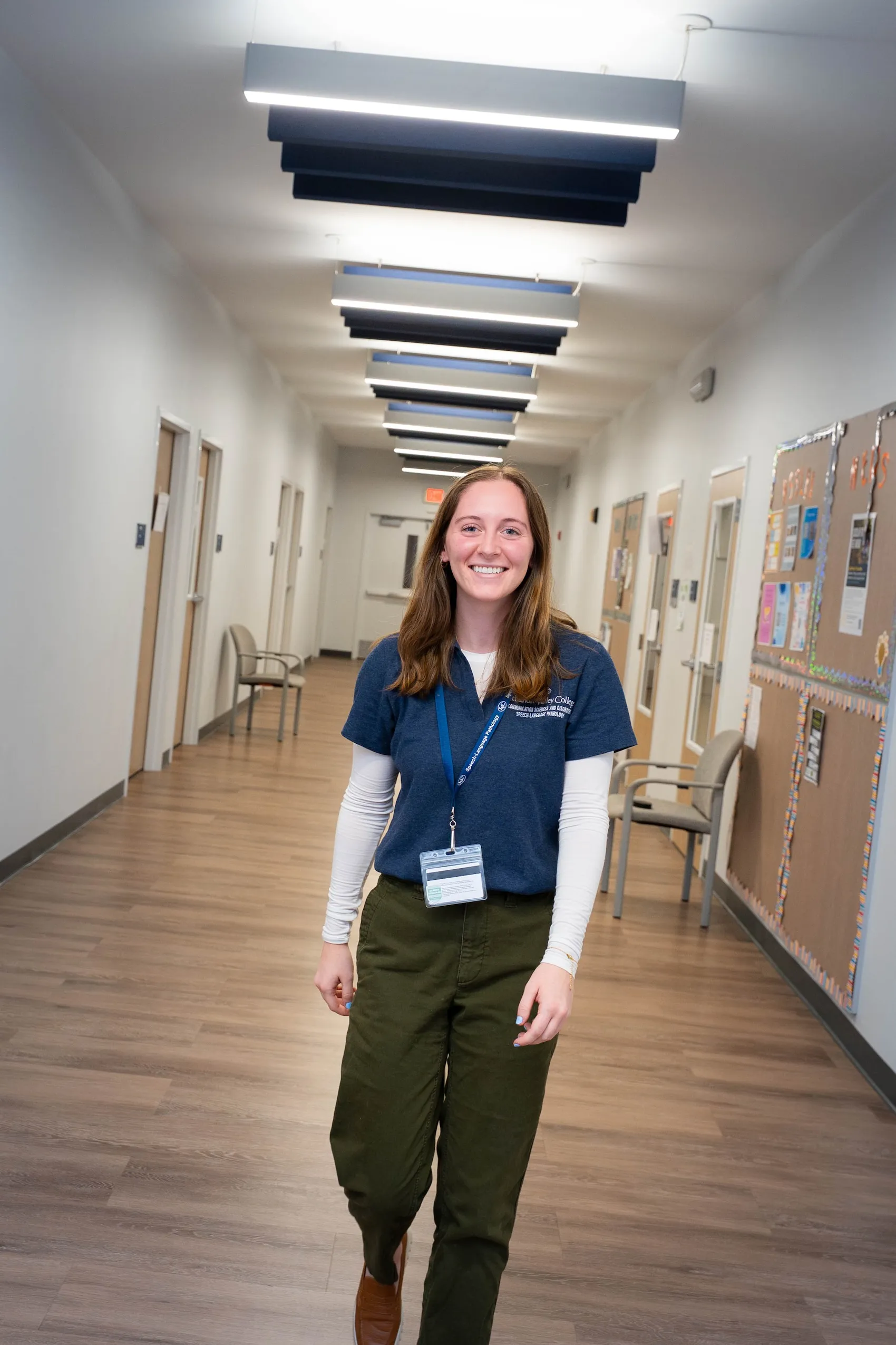 LVC speech-language pathology student walks through hallway of Center for Speech, Language, & Hearing Disorders