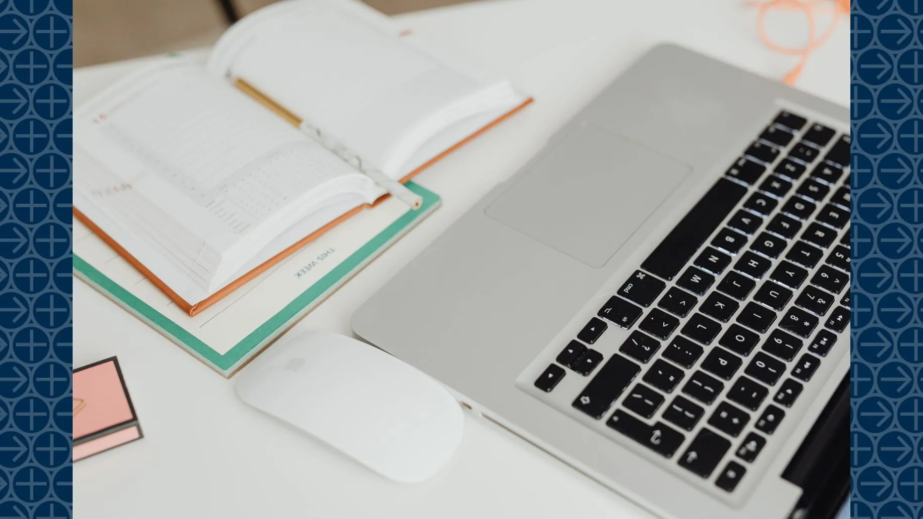 Laptop and open book sit on table