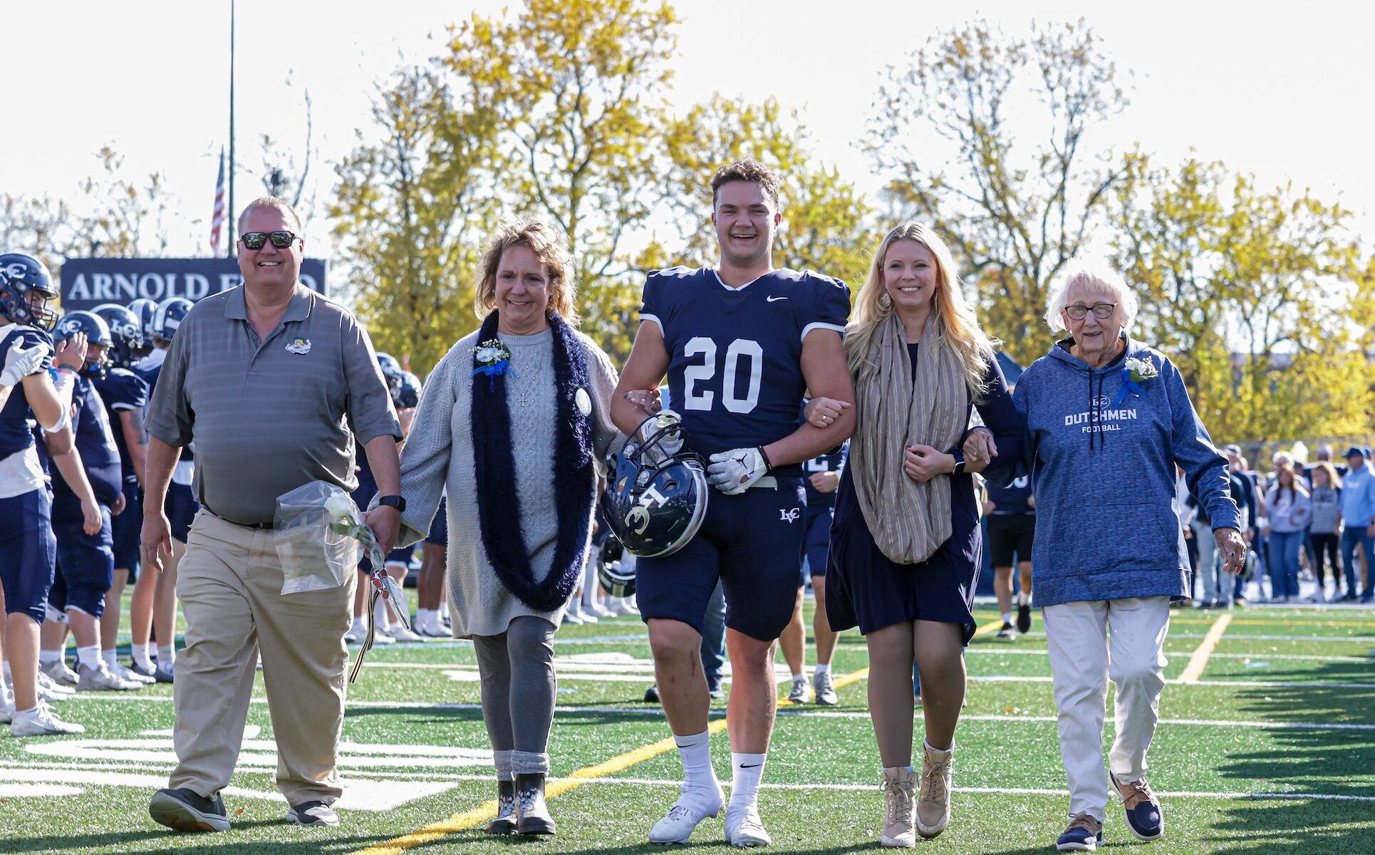 Ben Farmer on field with family at LVC Football senior day