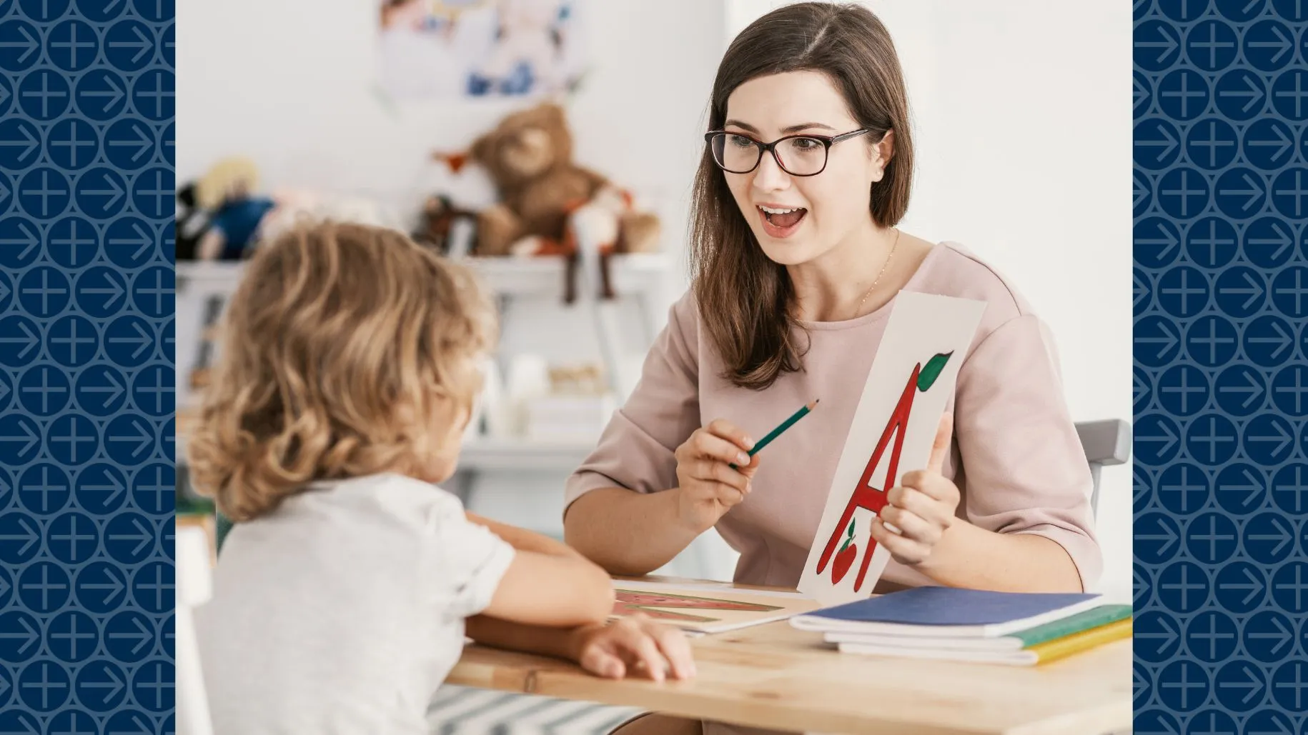 Speech-language pathologist points to letter A while working with young patient
