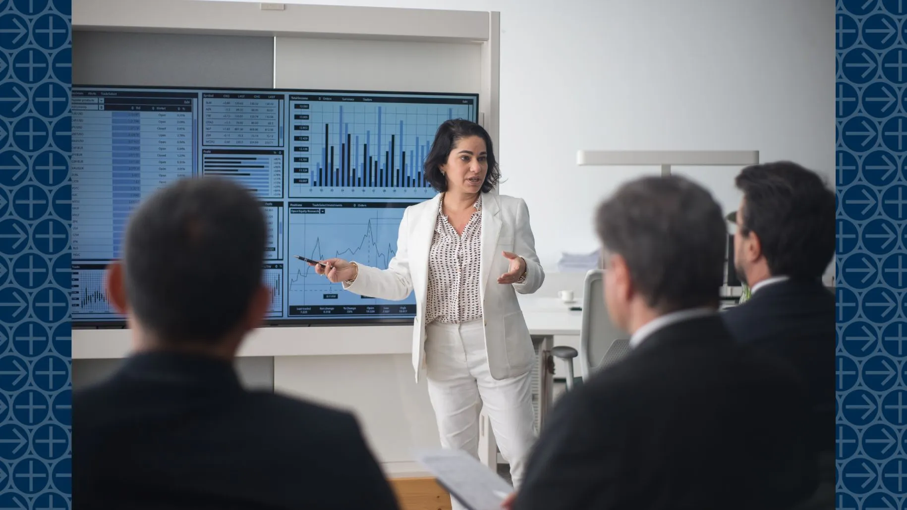 Business woman stands at front of room giving presentation