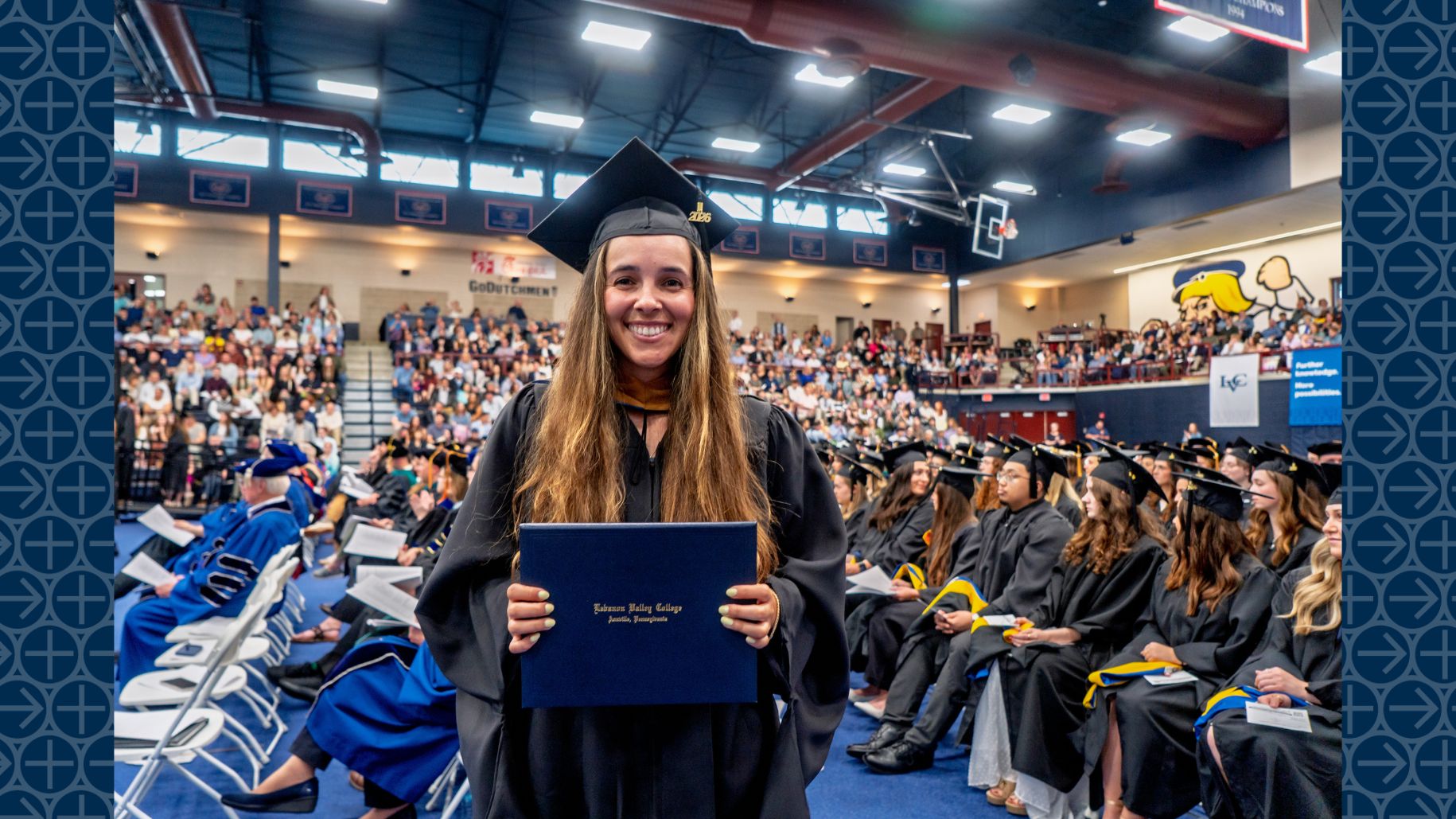 LVC Master of Business Administration (MBA) graduate poses with diploma folder at 2026 commencement ceremony
