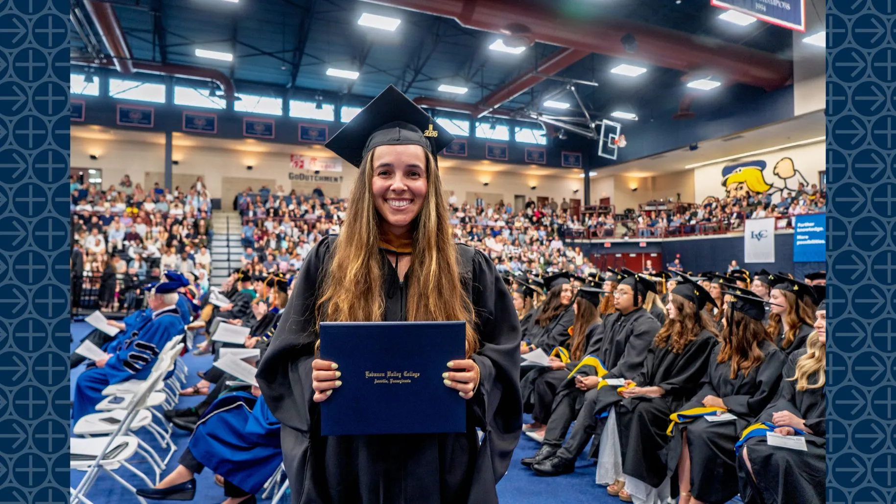 LVC Master of Business Administration (MBA) graduate poses with diploma folder at 2026 commencement ceremony