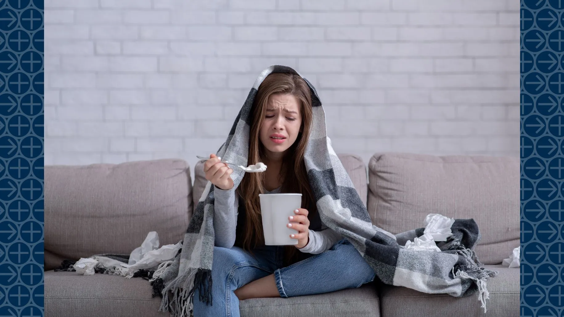 Young woman eats ice cream on couch while looking stressed
