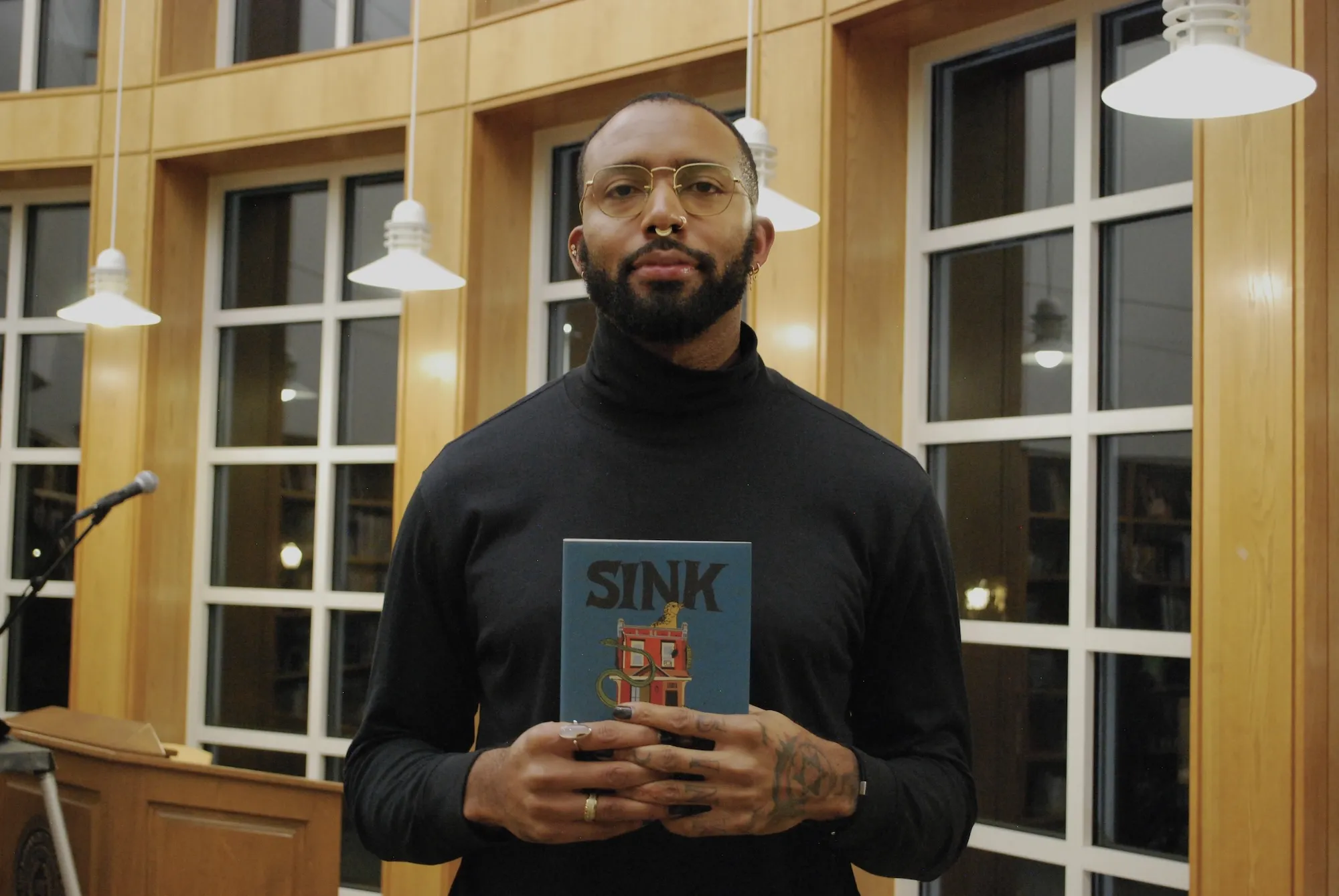 Joseph Earl Thomas with his memoir, "Sink"