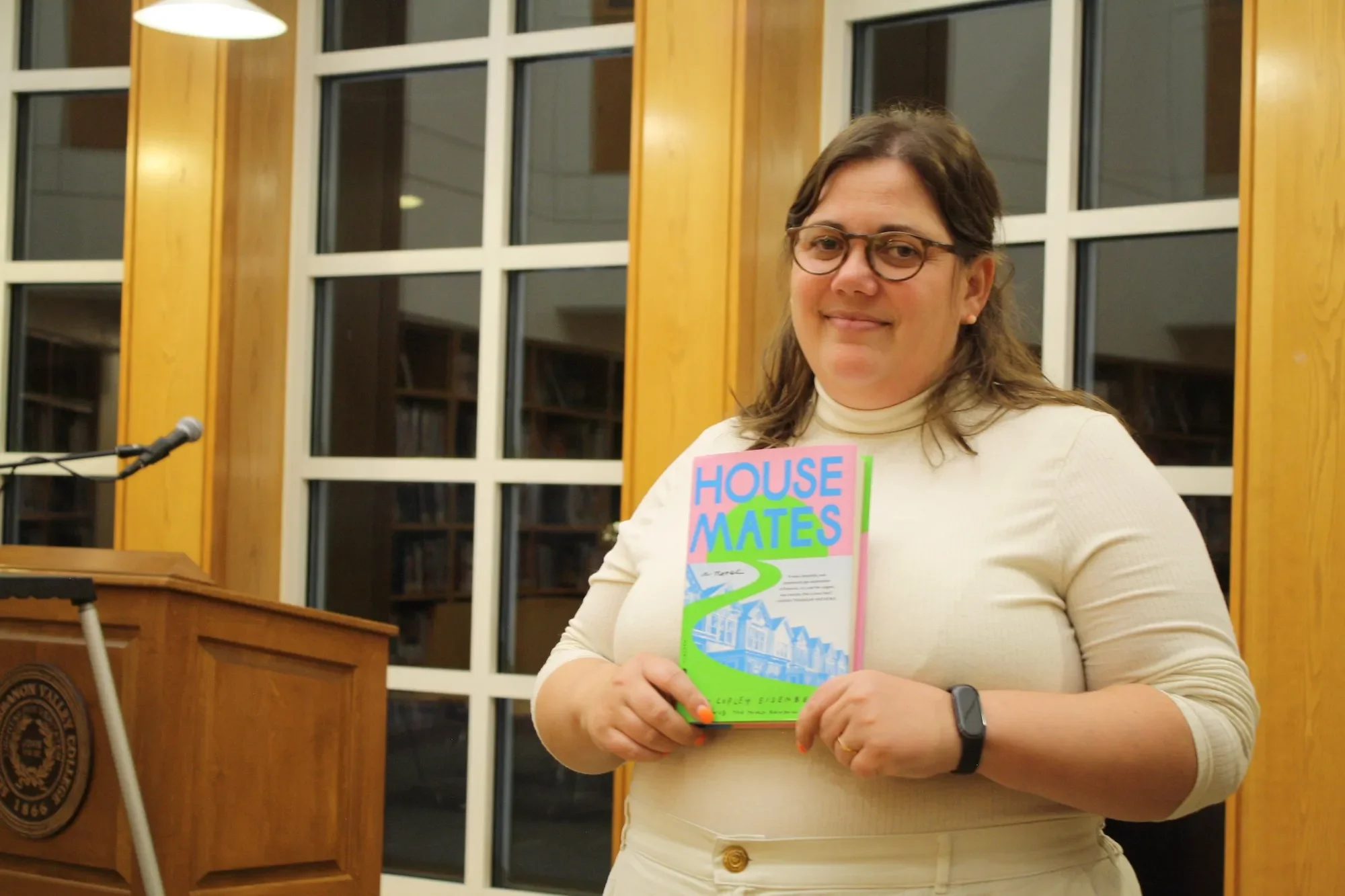 Emma Copley Eisenberg holds novel, "Housemates"