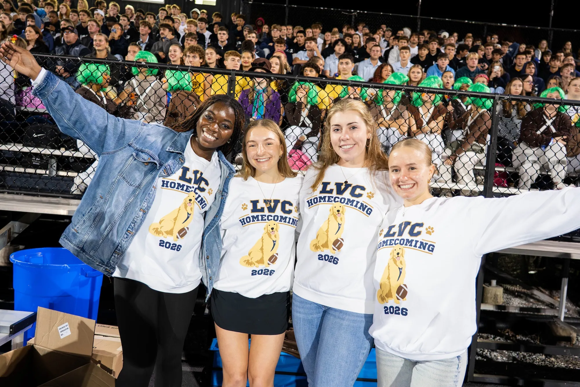 LVC students smile in front of crowd at pep rally