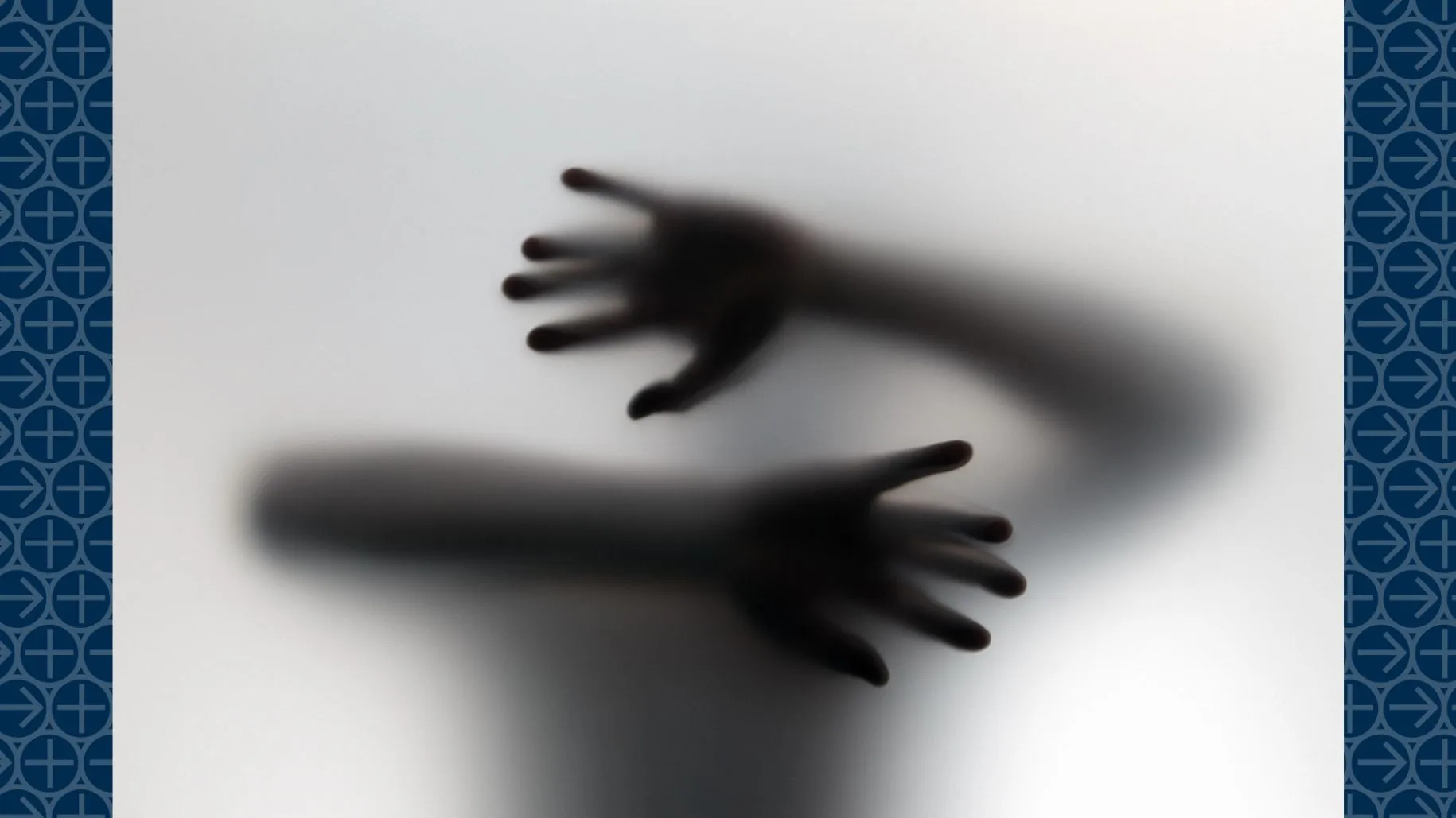 Shadow of hands show behind frosted glass wall